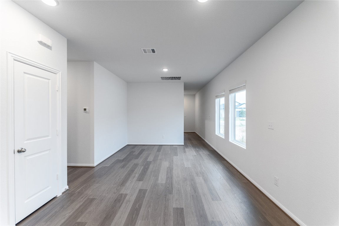 720 Barbary Coast Lane Jarrell, TX 76537 - Photo 7 of 19 an empty room with wooden floor and windows