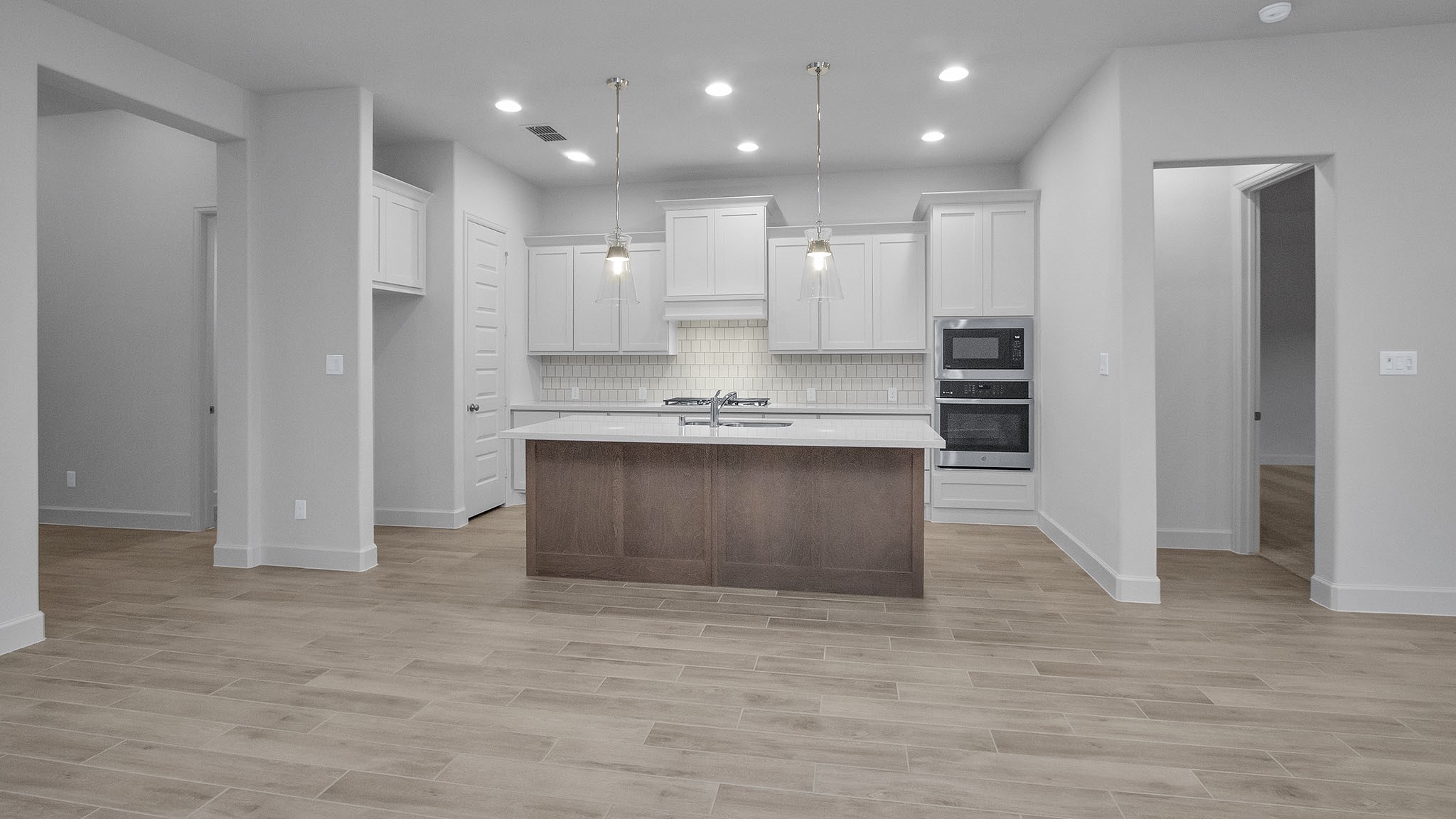 342 Prairie Warbler Street Magnolia, TX 77354 - Photo 12 of 24 a large kitchen with stainless steel appliances granite countertop a granite counter top and a refrigerator