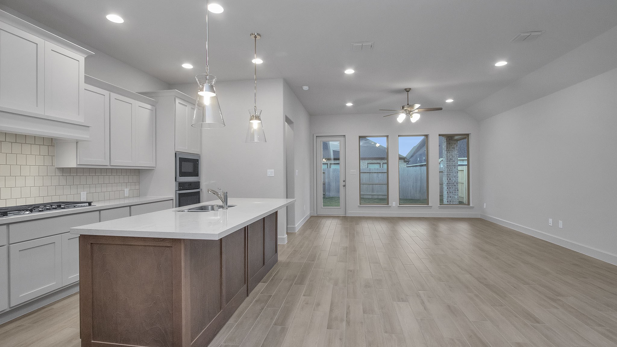 342 Prairie Warbler Street Magnolia, TX 77354 - Photo 5 of 24 a view of a kitchen with a sink cabinets and wooden floor