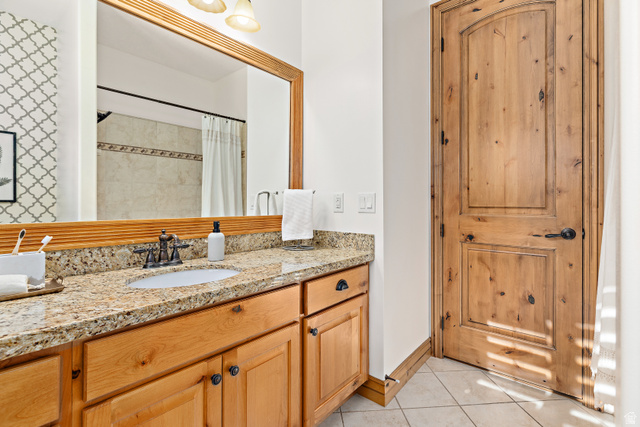 552 East Johns Way Sandy, UT 84070 - Photo 30 of 67 Wood-finish vanity with an undermount sink, granite-style countertop, and oil-rubbed bronze faucet
