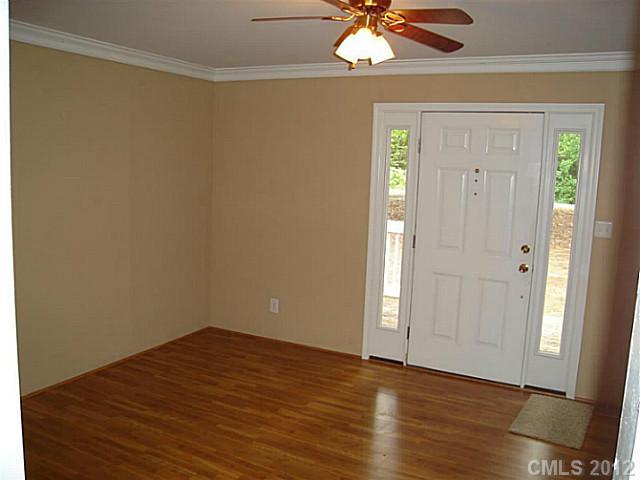 275 Frontier Road Clover, SC 29710 - Photo 2 of 12 an empty room with wooden floor closet and chandelier fan