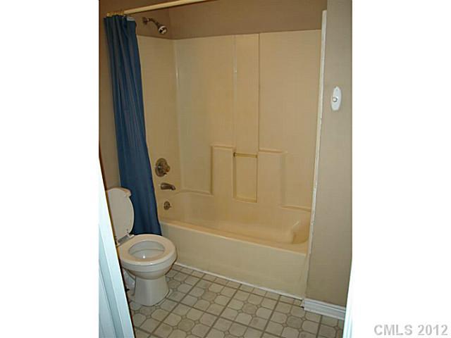 275 Frontier Road Clover, SC 29710 - Photo 9 of 12 a bathroom with a granite countertop bathtub shower and a toilet
