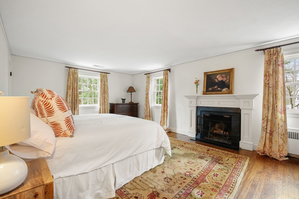 21 Alden Road Wellesley, MA 02481 - Photo 16 of 36 a bedroom with a bed and a fireplace