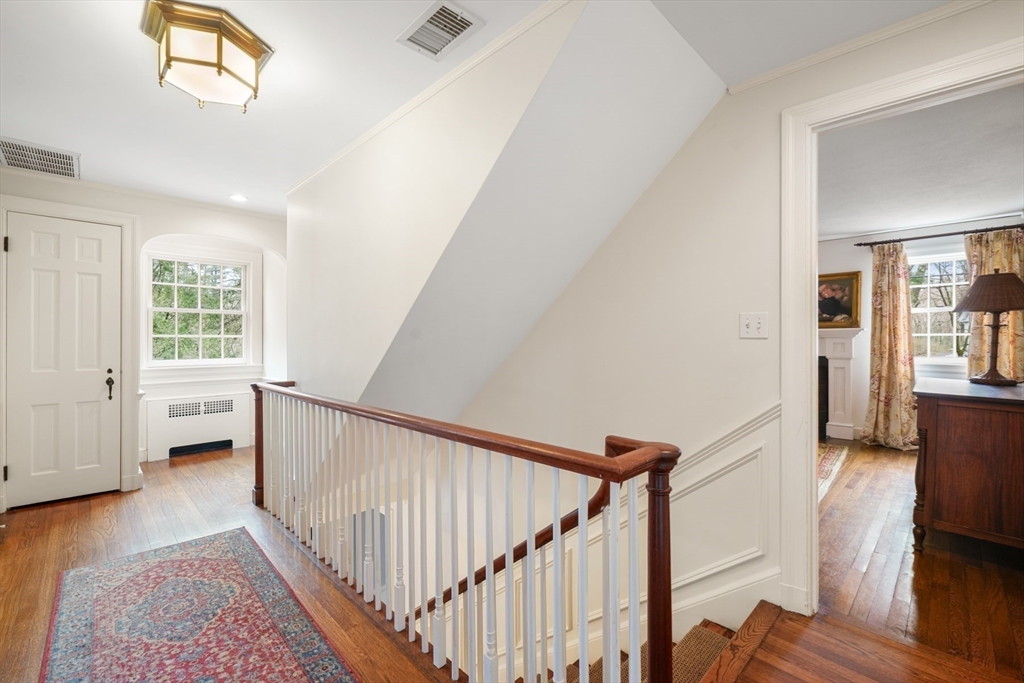 21 Alden Road Wellesley, MA 02481 - Photo 23 of 36 a view of a hallway with wooden floor and staircase