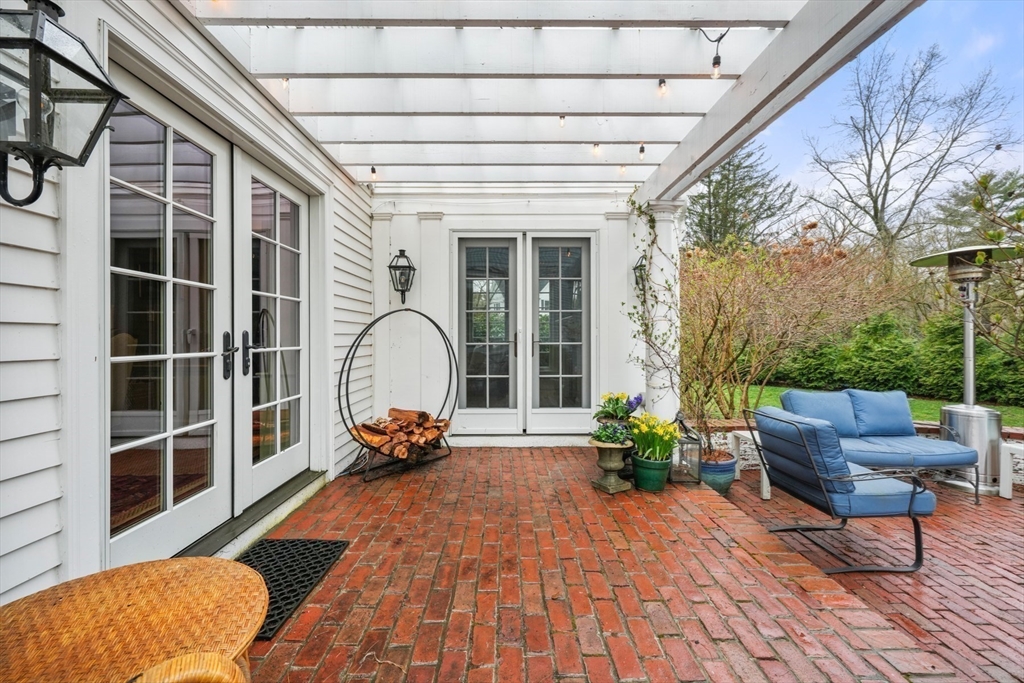 21 Alden Road Wellesley, MA 02481 - Photo 30 of 36 a view of a porch with furniture and a potted plant