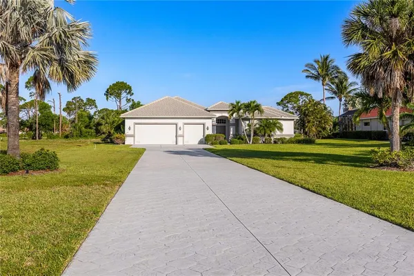 a view of a house with garden and a palm tree