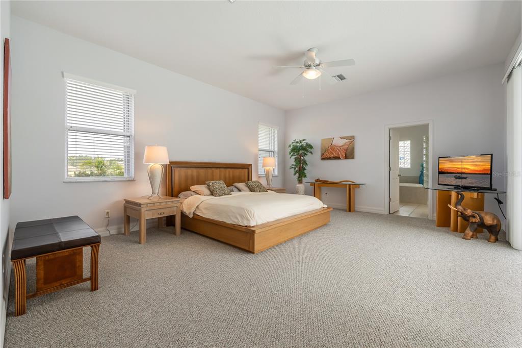 Undisclosed Address Punta Gorda, FL 33955 - Photo 16 of 46 a bedroom with a bed and a chandelier