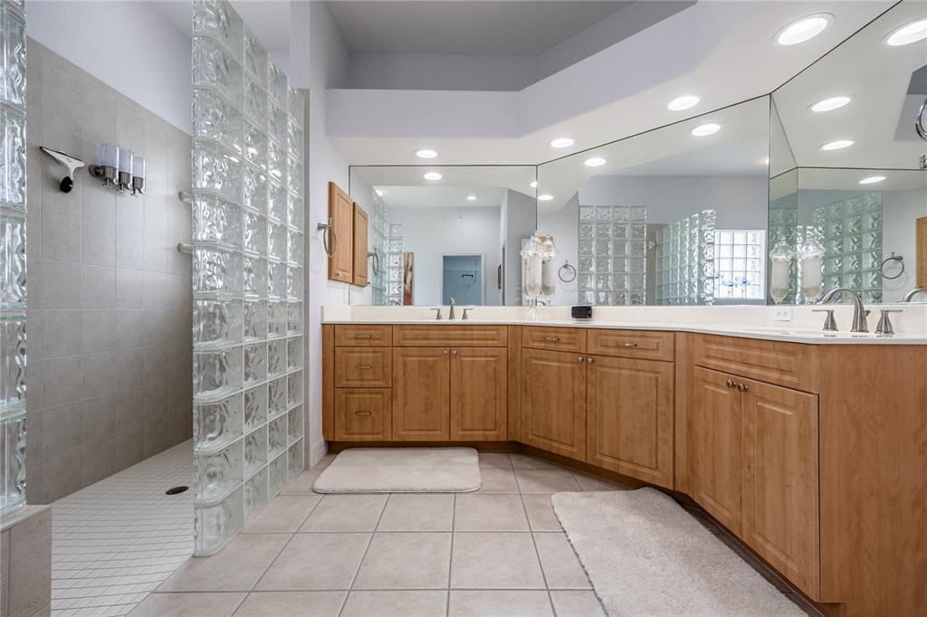 Undisclosed Address Punta Gorda, FL 33955 - Photo 18 of 46 a large bathroom with a sink a large mirror and a shower