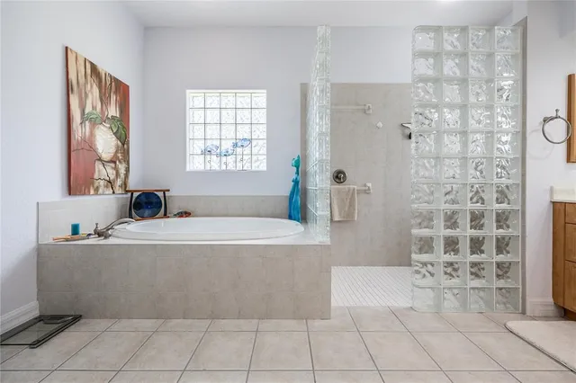 a bathroom with a granite countertop sink a toilet and a shower