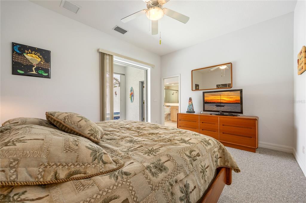 Undisclosed Address Punta Gorda, FL 33955 - Photo 24 of 46 a bedroom with a bed and a chandelier