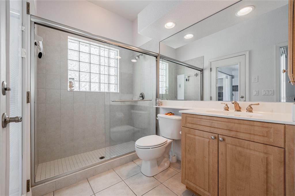 Undisclosed Address Punta Gorda, FL 33955 - Photo 25 of 46 a spacious bathroom with a granite countertop sink a toilet and a mirror