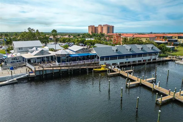 an aerial view of residential houses with outdoor space and river