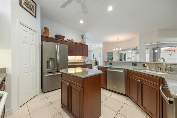 a kitchen with stainless steel appliances granite countertop a sink stove and refrigerator