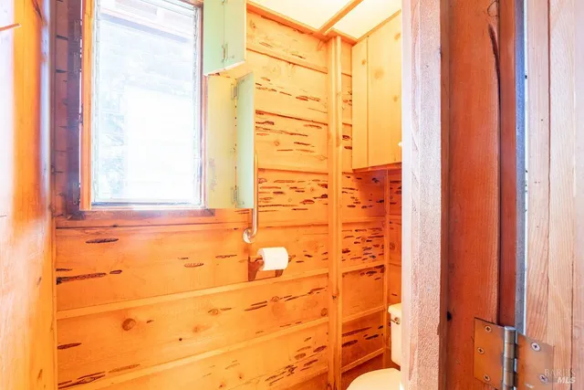 a view of a big room with wooden floor and windows