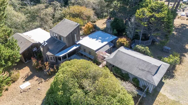 an aerial view of a house with a yard basket ball court and outdoor seating