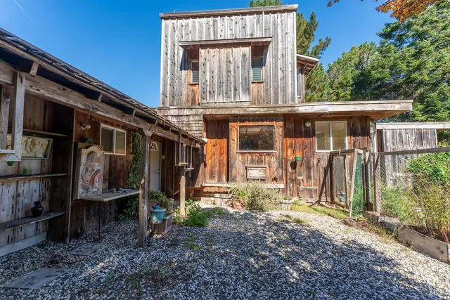 a view of a lake with a bench and trees around