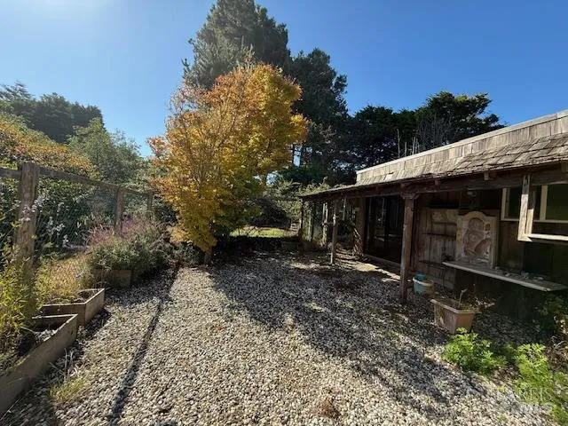 a view of a lake with a bench and trees around