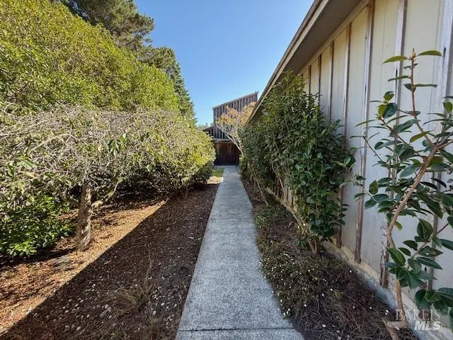 a view of a balcony with wooden floor and fence