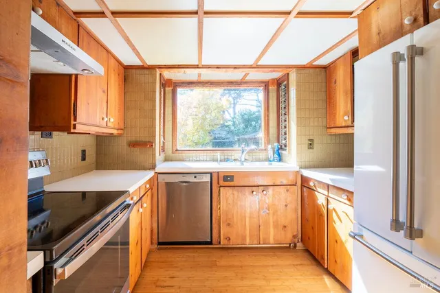 a kitchen with stainless steel appliances granite countertop a sink and a stove