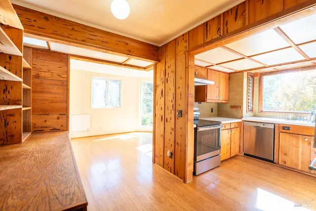 a kitchen with stainless steel appliances granite countertop a refrigerator a sink and a stove