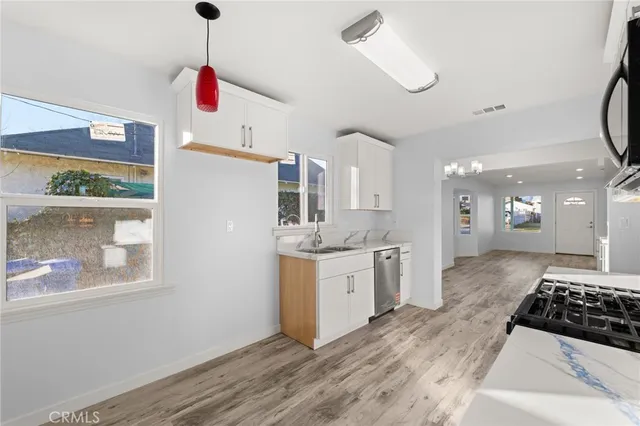 a kitchen with stainless steel appliances granite countertop a stove and a sink