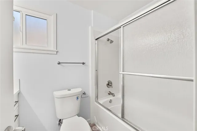 a bathroom with a toilet and shower