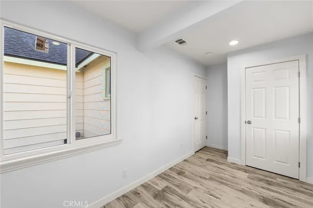 a view of a livingroom with wooden floor and window