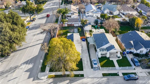 an aerial view of residential houses with outdoor space