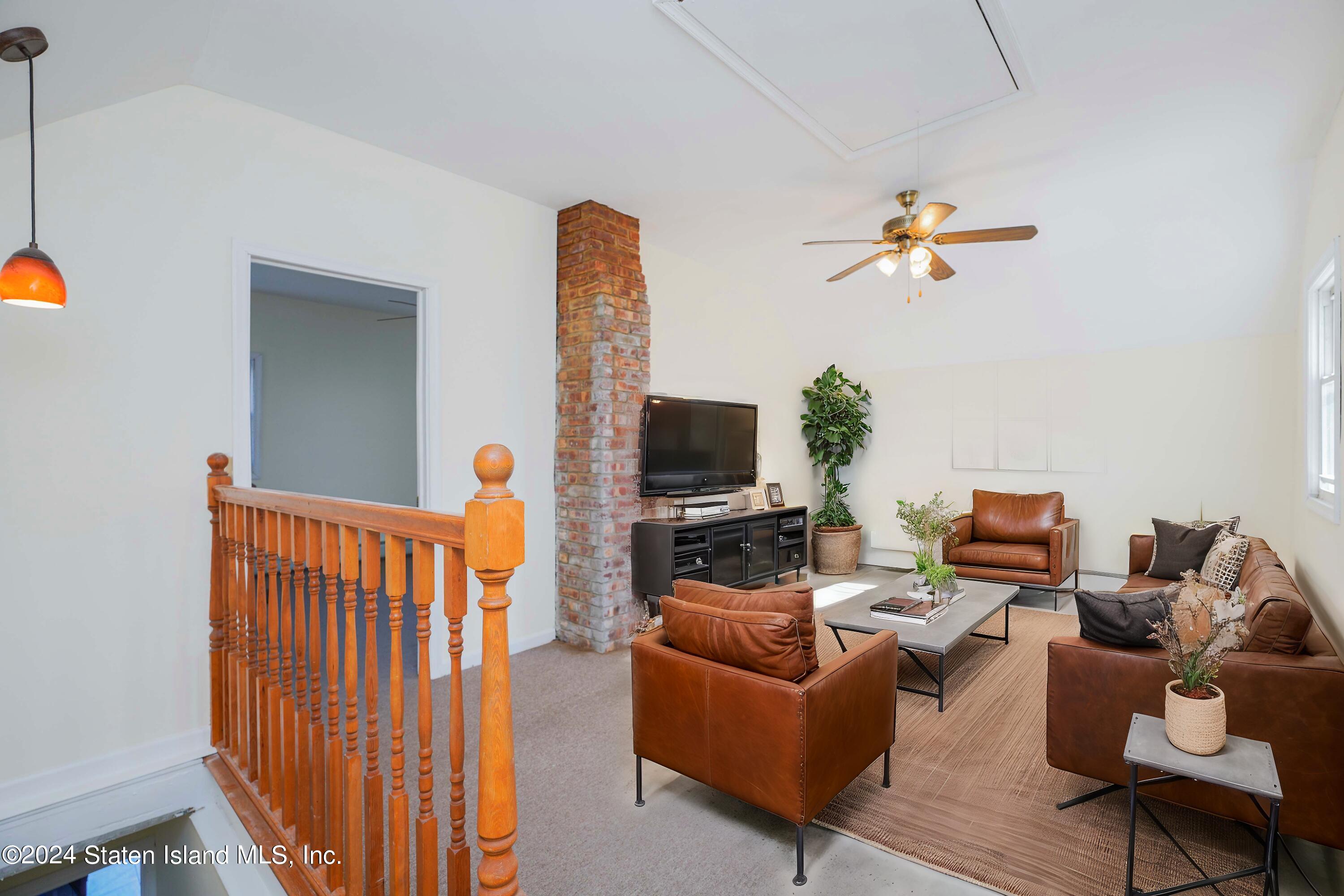 74 Fingerboard Road Staten Island, NY 10305 - Photo 11 of 18 a living room with furniture and a flat screen tv