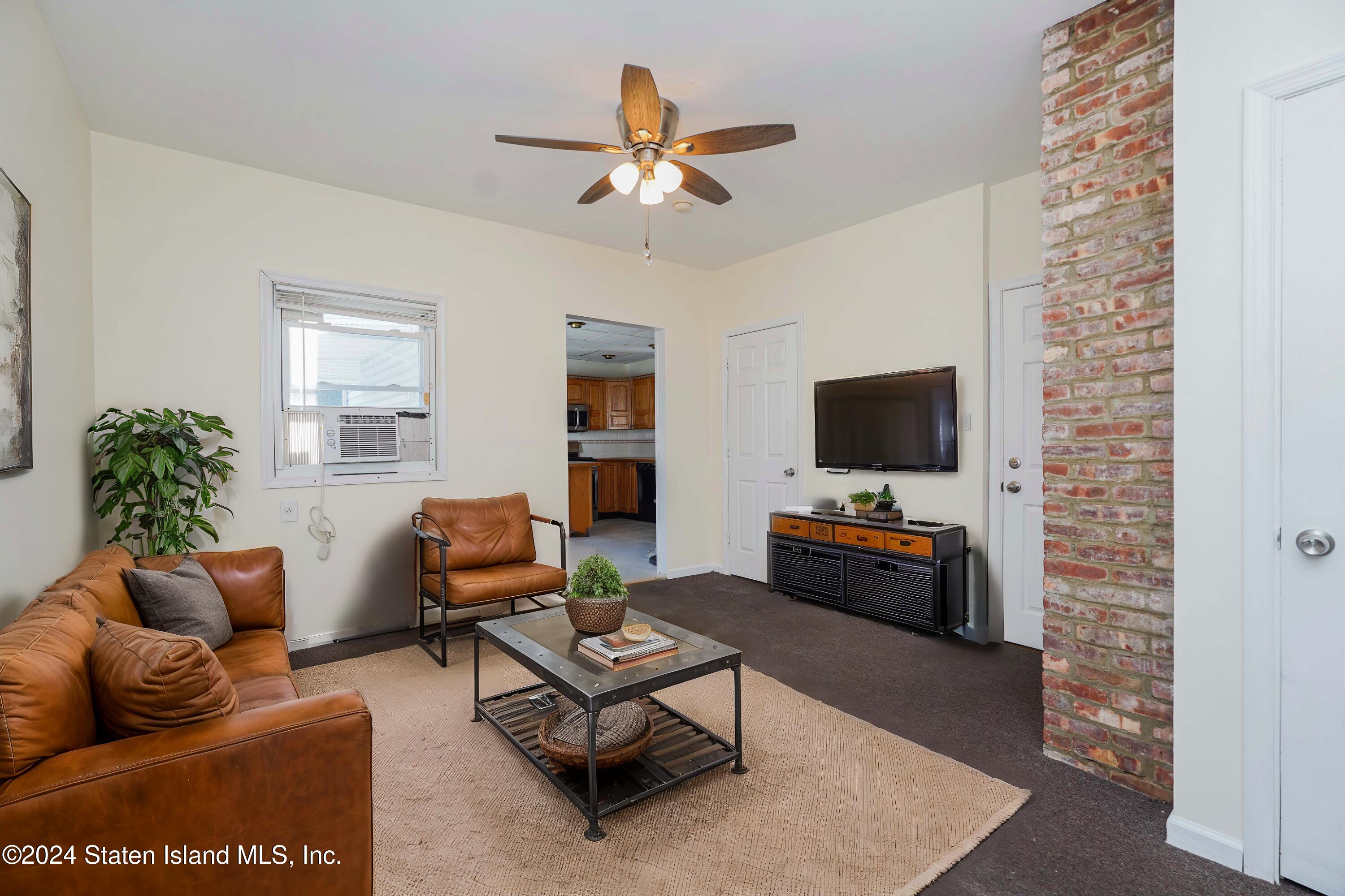 74 Fingerboard Road Staten Island, NY 10305 - Photo 12 of 18 a living room with furniture and a flat screen tv