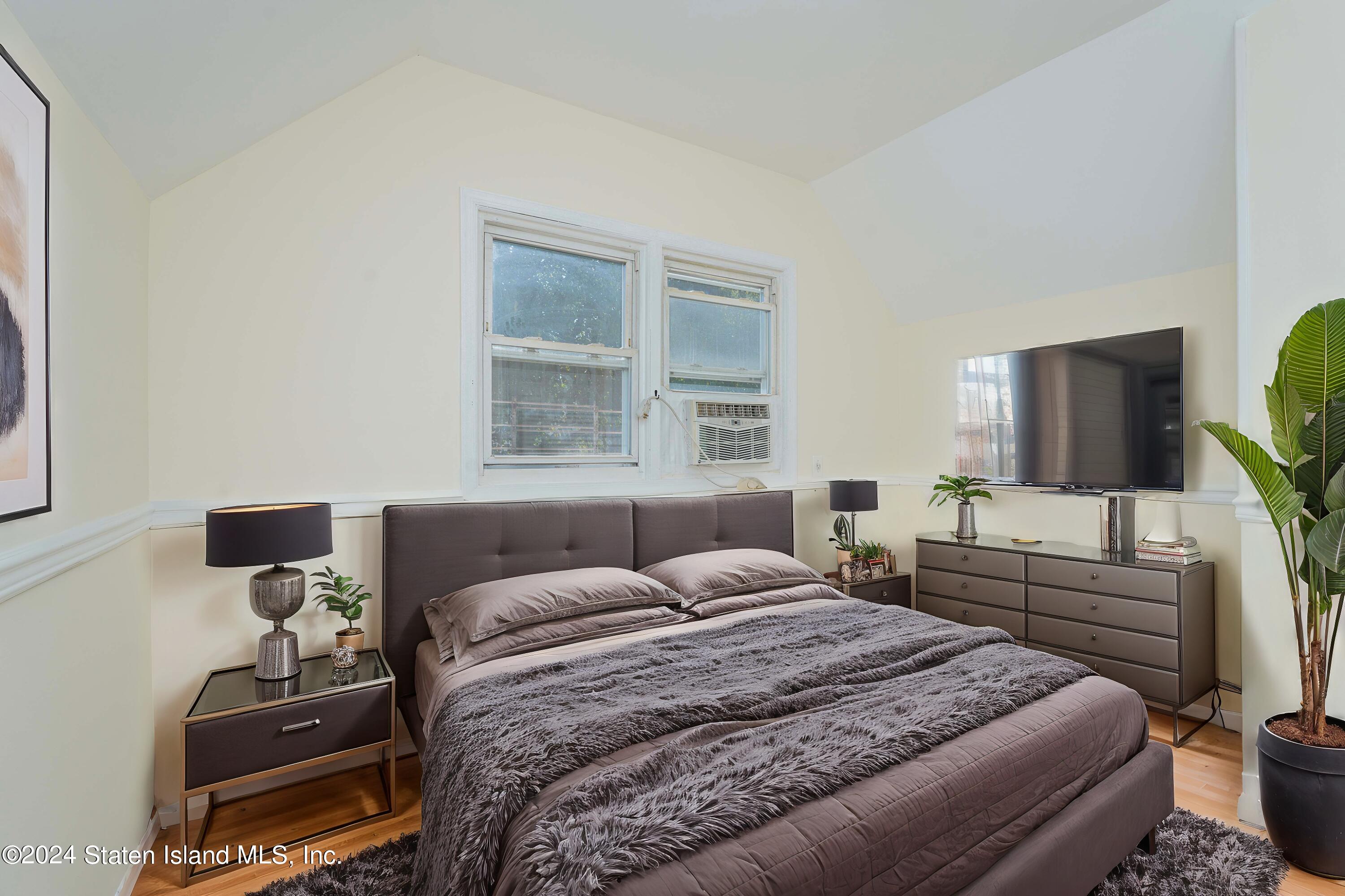 74 Fingerboard Road Staten Island, NY 10305 - Photo 13 of 18 a bedroom with a bed and a flat screen tv