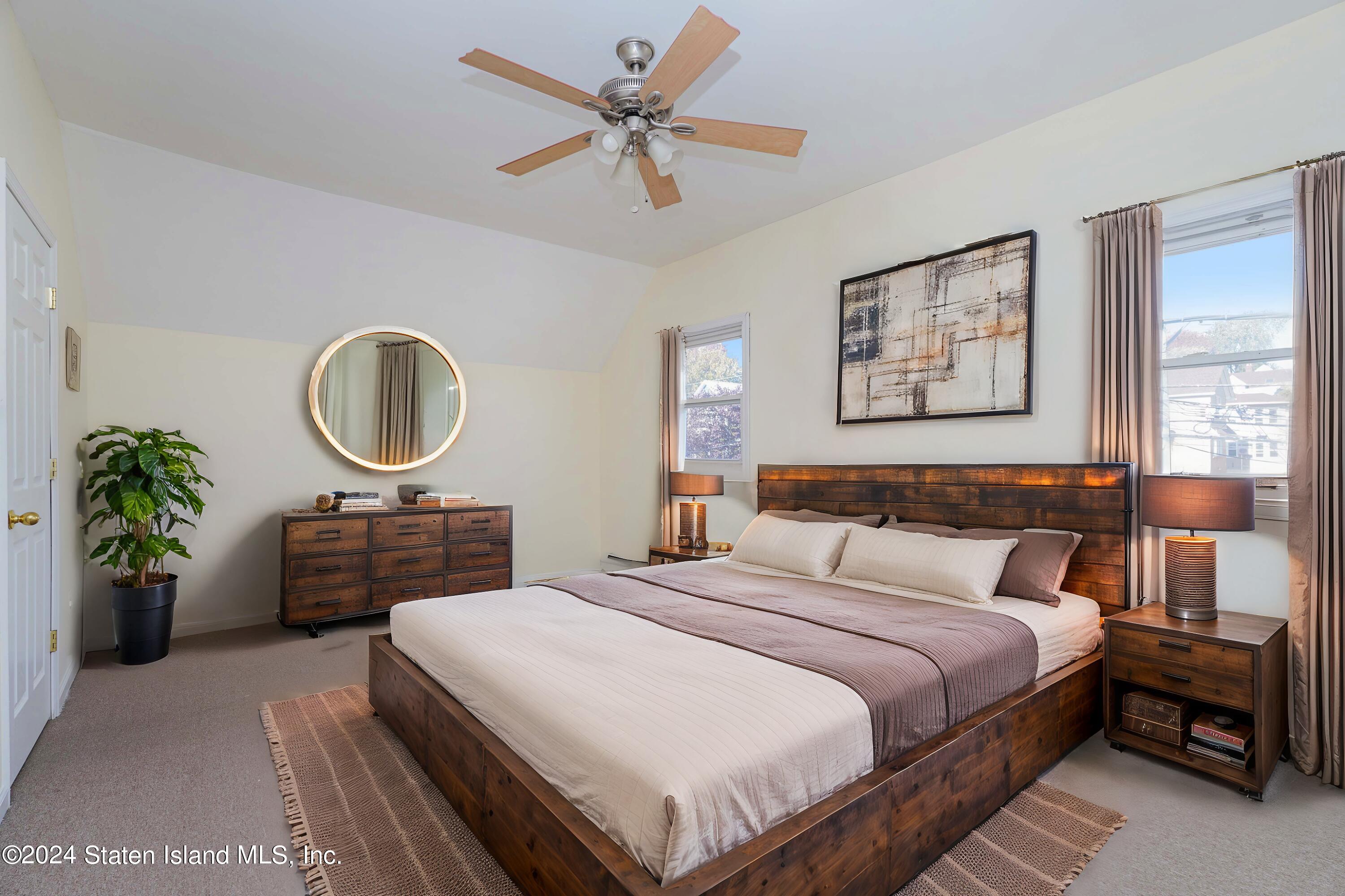 74 Fingerboard Road Staten Island, NY 10305 - Photo 16 of 18 a bedroom with a bed and a chandelier