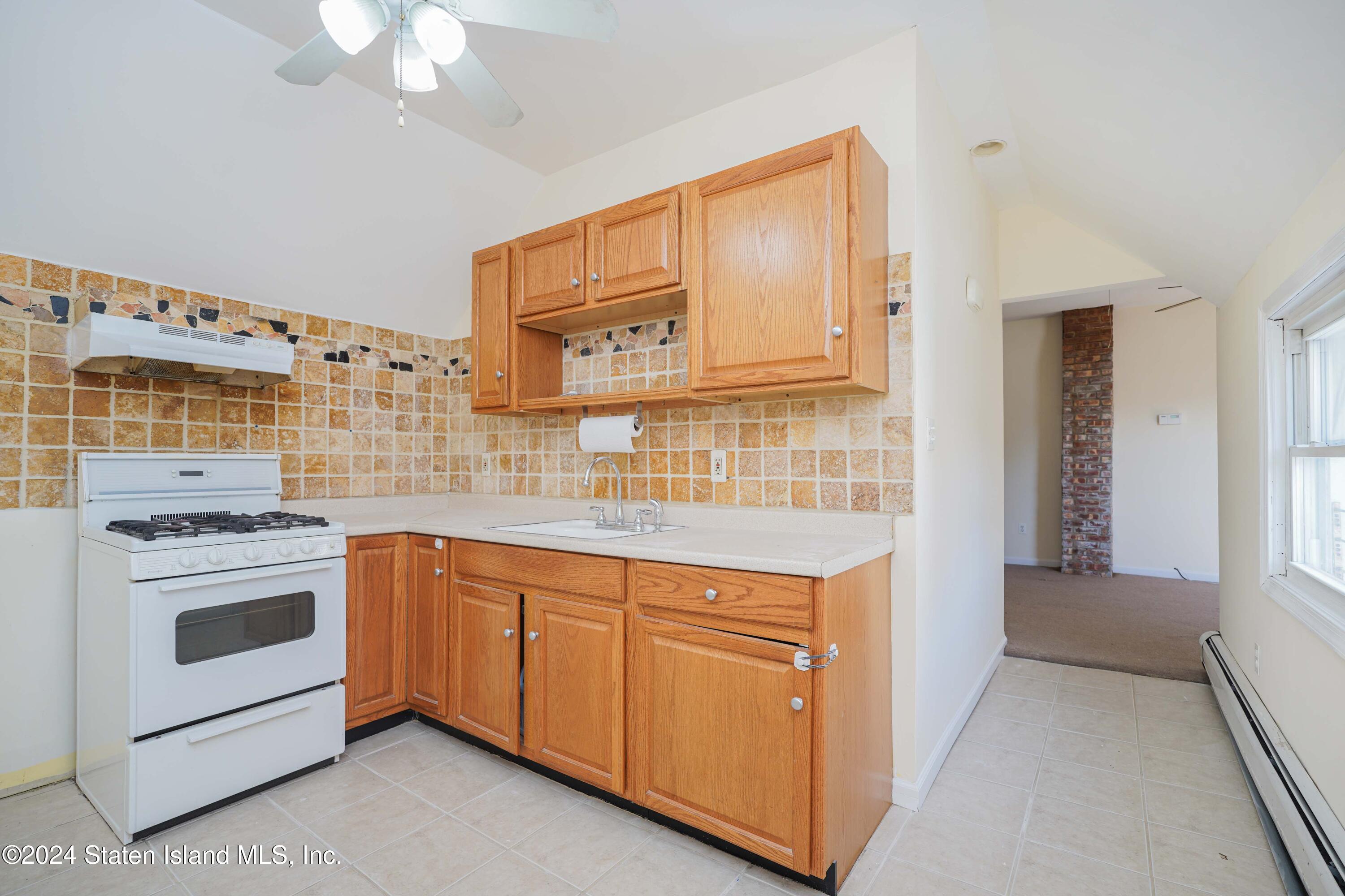 74 Fingerboard Road Staten Island, NY 10305 - Photo 18 of 18 a kitchen with stainless steel appliances granite countertop a stove and a sink