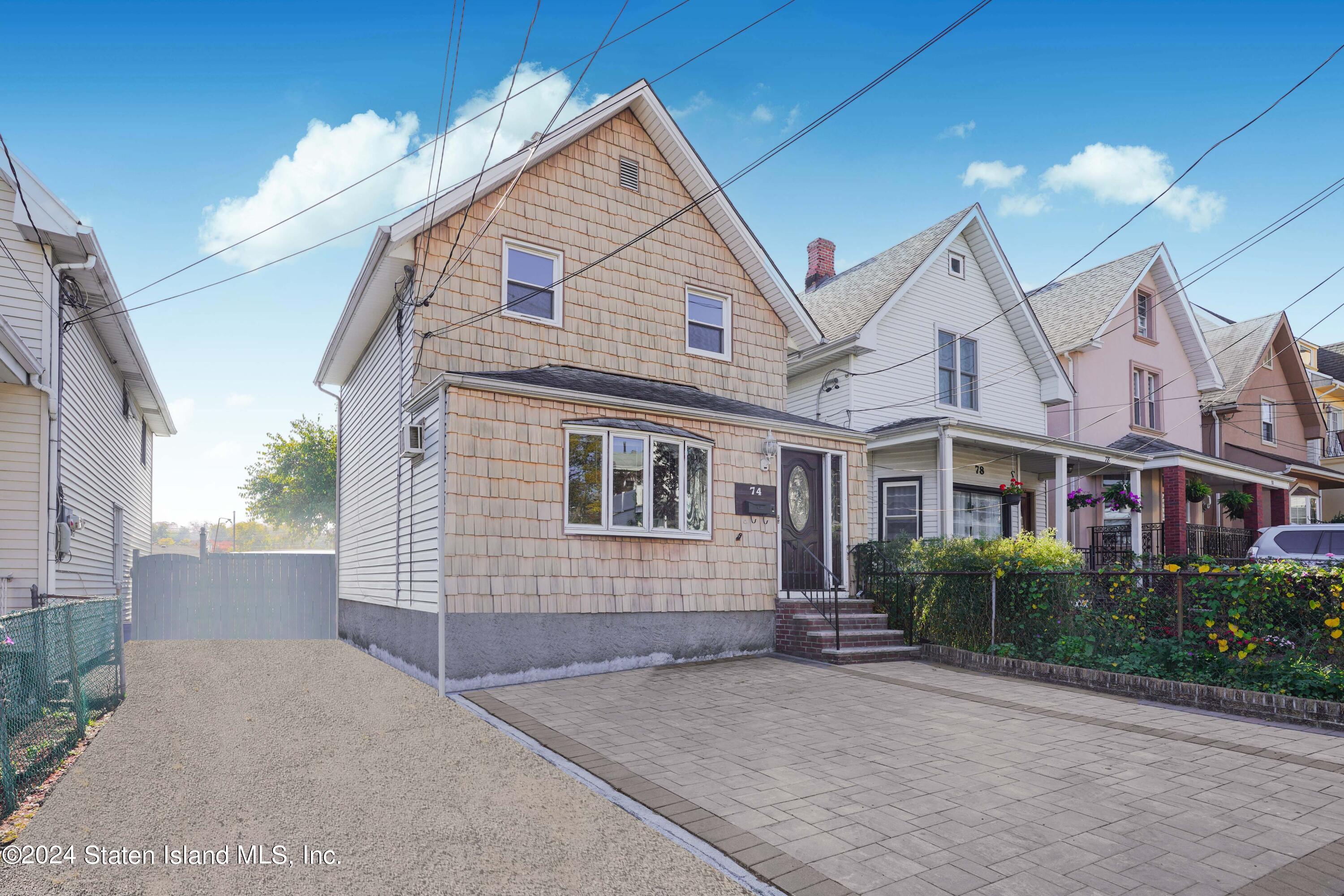 74 Fingerboard Road Staten Island, NY 10305 - Photo 2 of 18 a view of a house next to a yard