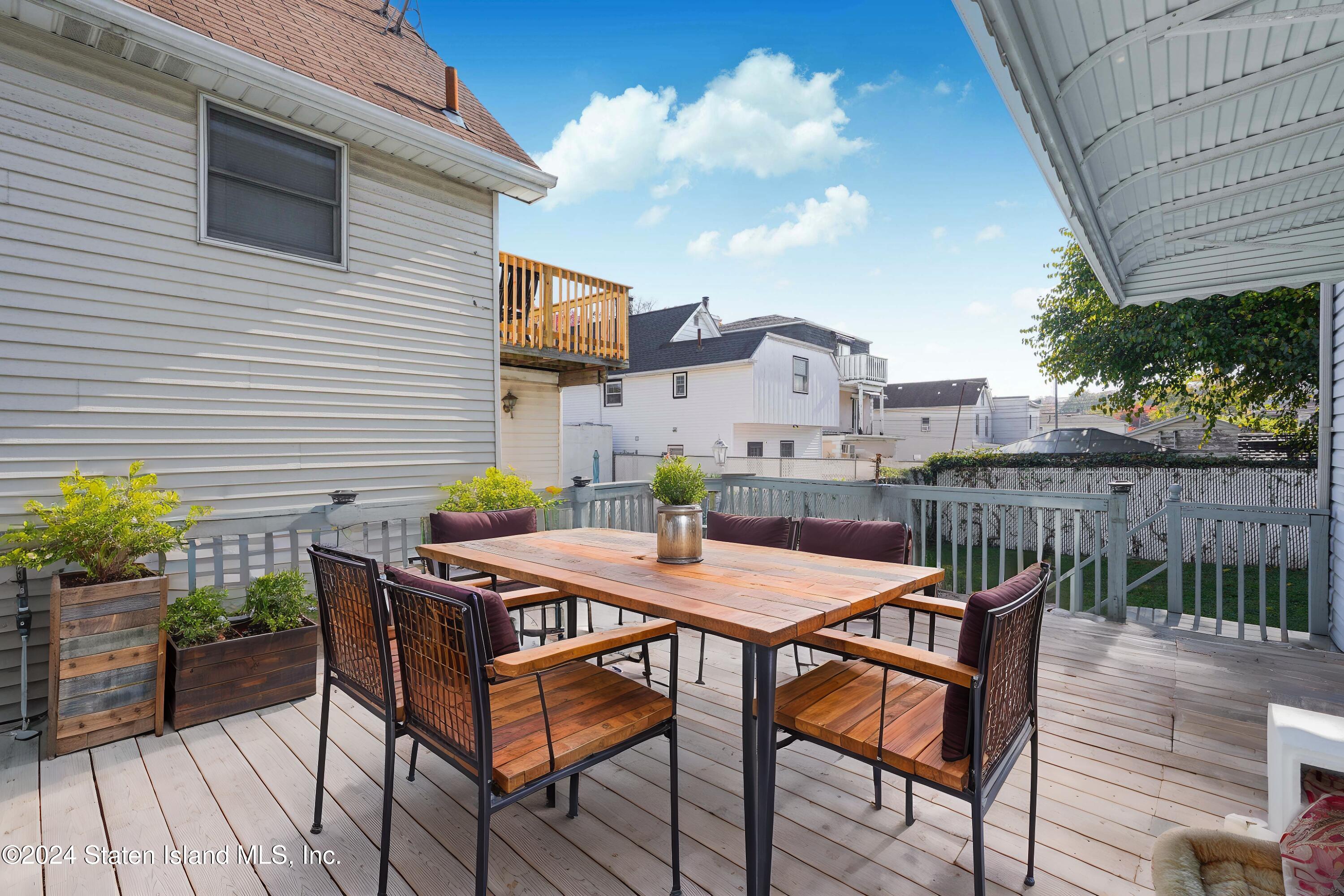 74 Fingerboard Road Staten Island, NY 10305 - Photo 4 of 18 a table and chairs in front of a house