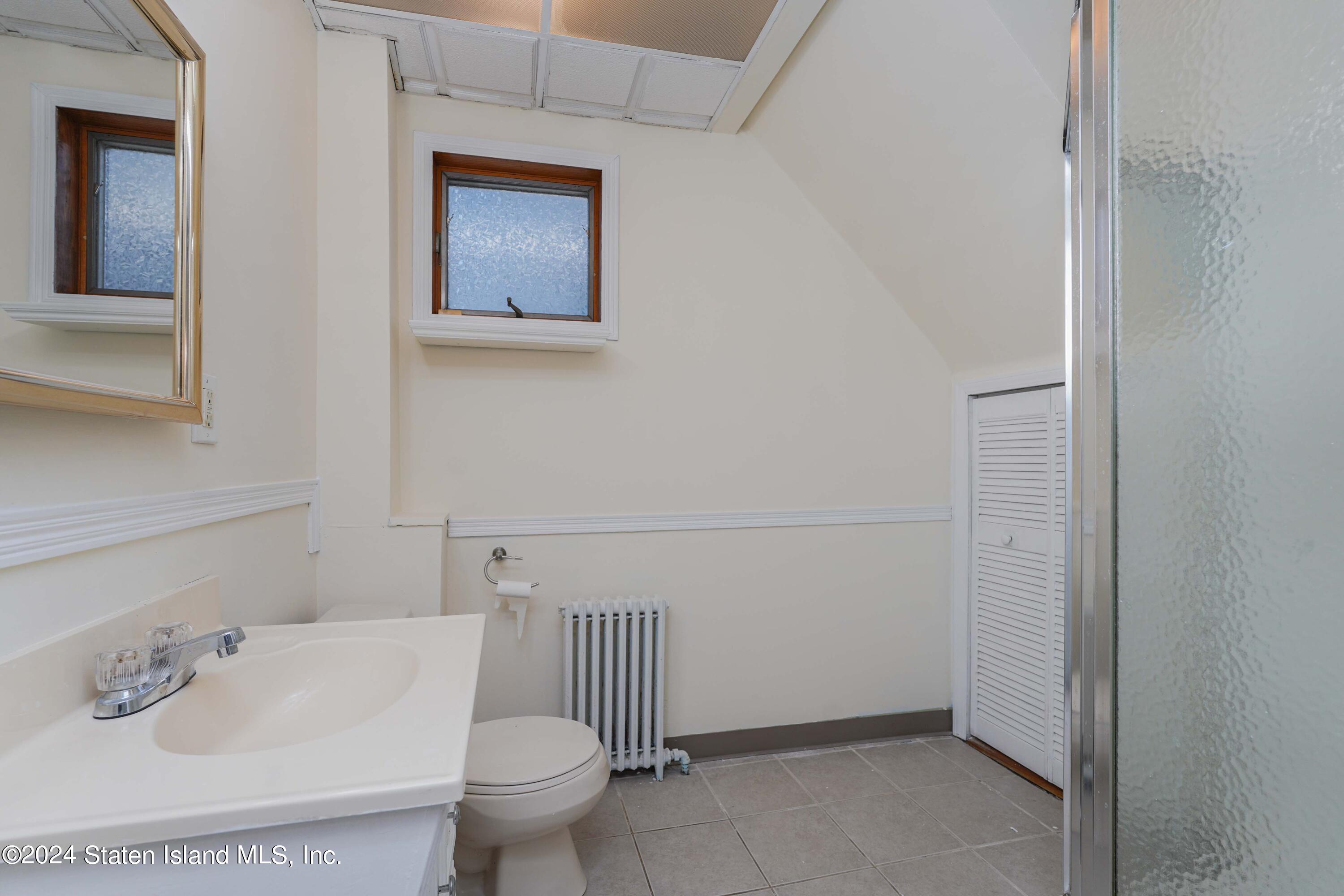 74 Fingerboard Road Staten Island, NY 10305 - Photo 7 of 18 a bathroom with a toilet and a sink