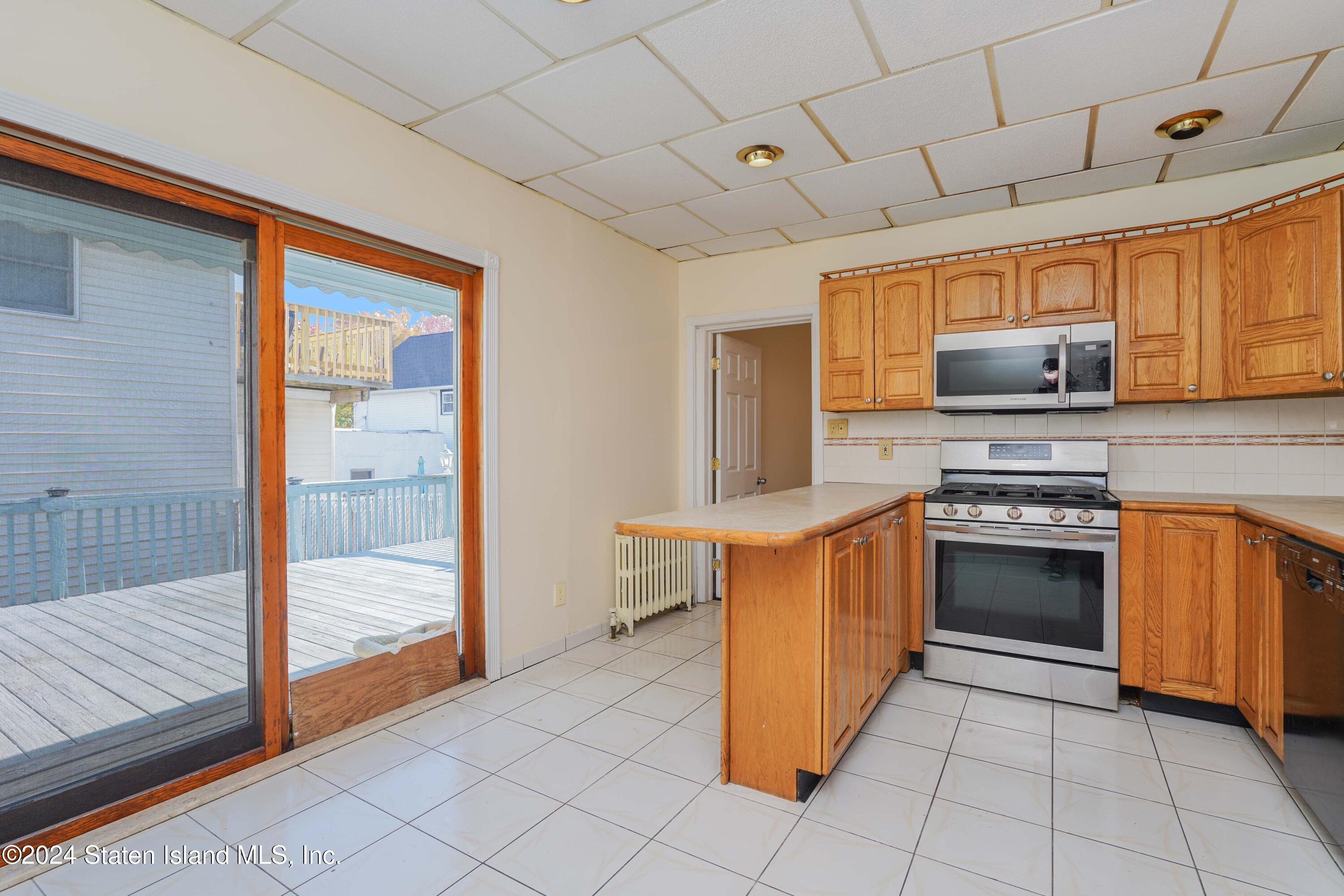 74 Fingerboard Road Staten Island, NY 10305 - Photo 10 of 18 a kitchen with stainless steel appliances granite countertop a stove a sink and a microwave