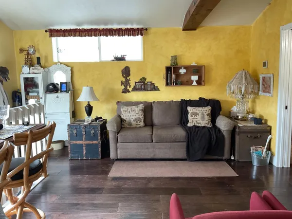 a living room with furniture and a floor to ceiling window