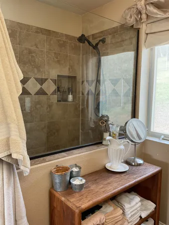 a en suite bathroom with a granite countertop sink and a mirror