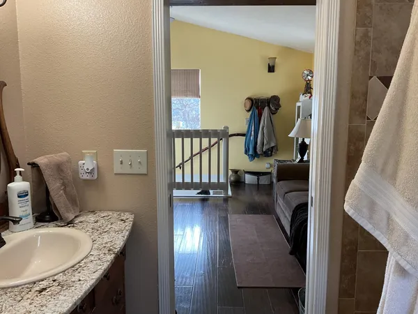 a bathroom with a granite countertop toilet sink and mirror