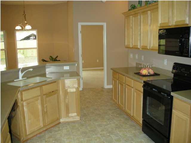 75 Eastern Street Freeport, FL 32439 - Photo 9 of 14 a kitchen with stainless steel appliances granite countertop a sink stove and cabinets