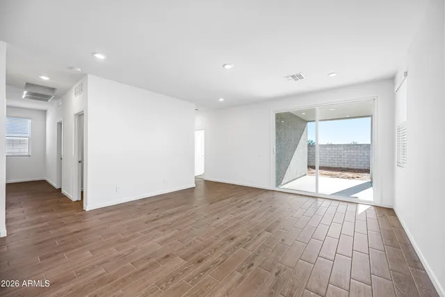 an empty room with wooden floor and door
