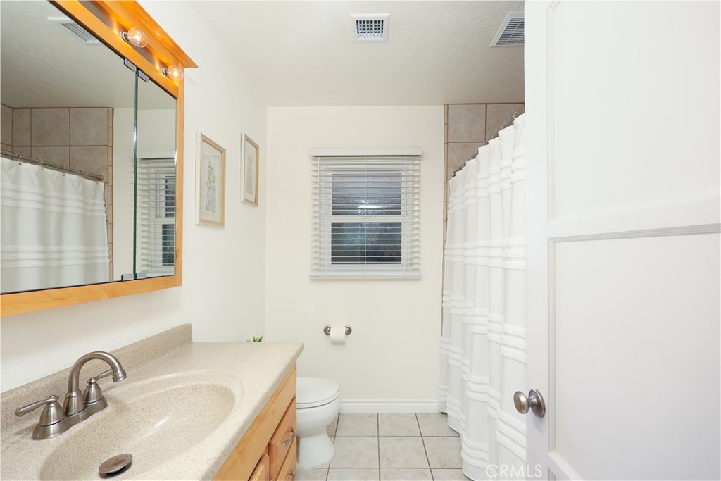 6116 Arbor Road Lakewood, CA 90713 - Photo 17 of 46 a bathroom with a sink toilet and shower
