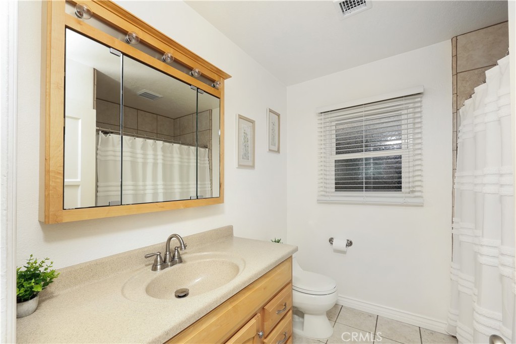 6116 Arbor Road Lakewood, CA 90713 - Photo 18 of 46 a bathroom with a sink toilet and mirror