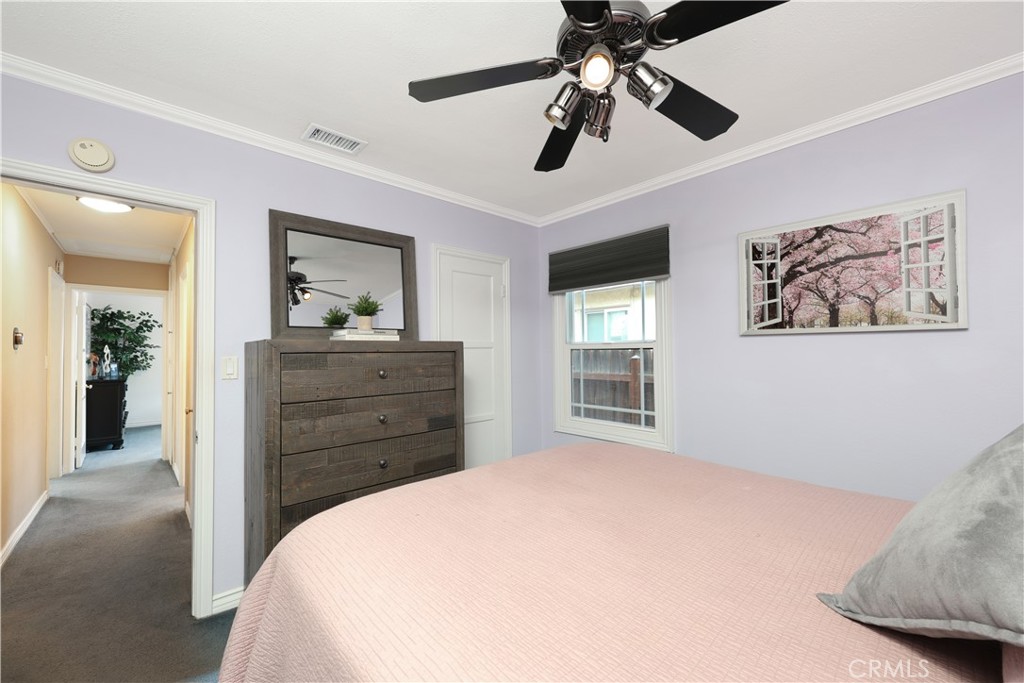 6116 Arbor Road Lakewood, CA 90713 - Photo 22 of 46 a bedroom with a bed and a chandelier