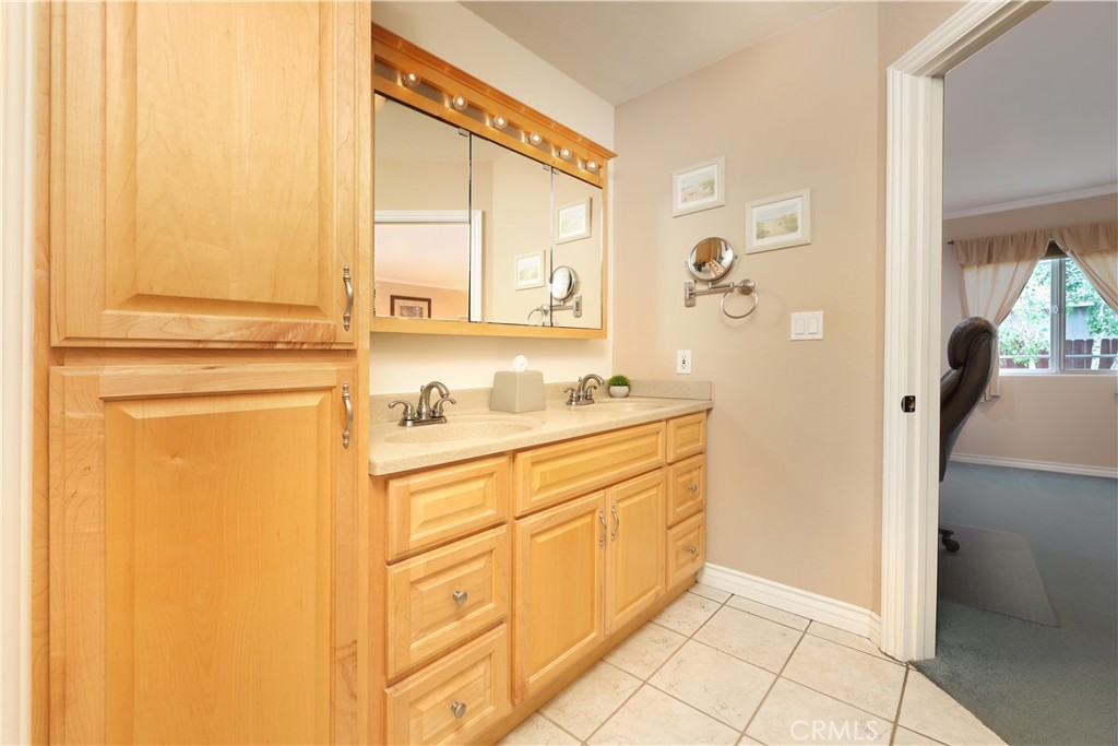 6116 Arbor Road Lakewood, CA 90713 - Photo 29 of 46 a bathroom with a sink a mirror and a shower