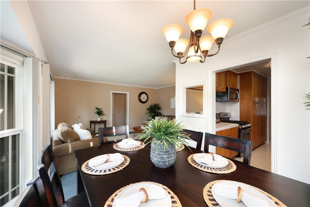 6116 Arbor Road Lakewood, CA 90713 - Photo 10 of 46 a dining room with furniture a potted plant and wooden floor