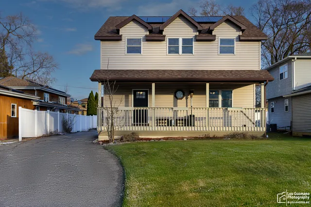 a front view of a house with a garden
