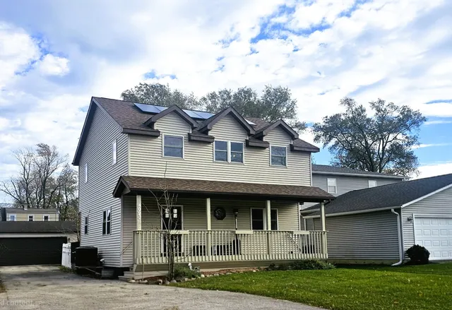 a front view of a house with a garden