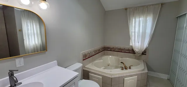 a bathroom with a toilet a sink and shower